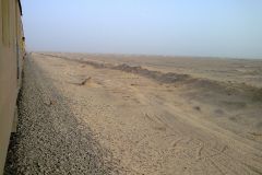 Desert landscape at the edge of the railway line between Al Faiyum and Al Wasta in Egypt.
