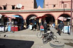 Street Food Stalls and Local Cafes Along an Arcade in Essaouira Medina During Daytime