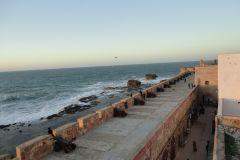Atlantic Ocean Ramparts of Essaouira with Historic Cannons, Pedestrians, and Waves at Late Afternoon