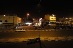 Nighttime Street Scene in Inezgane with Parked Cars, Lit Buildings, and Quiet Urban Atmosphere