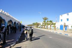 Busy Street with Arcaded Building and Pedestrians in Sidi Ifni