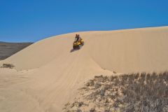 Quad driving at the coast of Coral Bay, Western Australia