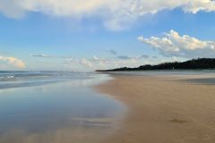 Wide Tidal Beach Under Soft Afternoon Clouds
