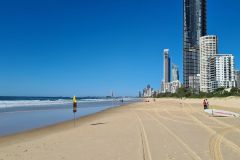 Surfers Paradise Beach with Lifeguard Flags and Skyline