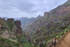 Cliffside section of PR1 Vereda do Areeiro overlooking central Madeira mountains, Portugal