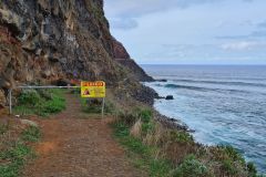 Cliffside Coastal Path with Rockfall Warning near São Jorge, Madeira