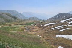 High Alpine Valley with Snow Patches Near Col du Galibier, French Alps