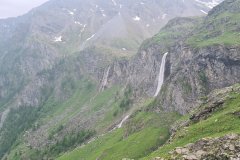 Spring Waterfalls Cascading Down a Steep Alpine Valley in the Italian Alps