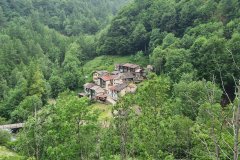 Forest-Enclosed Alpine Hamlet in a Mountain Valley of the Italian Alps