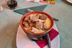 Traditional Alpine Cheese Fondue Served in a Mountain Restaurant of the Italian Alps