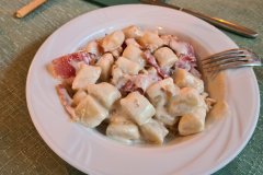 Traditional Alpine Gnocchi Dish Served in a Mountain Restaurant of the Italian Alps