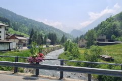 Alpine village beside a mountain stream in a high valley landscape