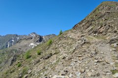 Rocky High-Altitude Trail Traversing a Steep Alpine Ridge