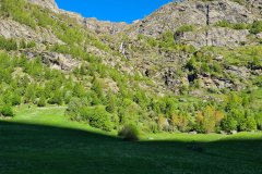 Rocky Alpine Cliffs and Spring Meadow Below Cascading Stream in Val d’Ayas, Aosta Valley