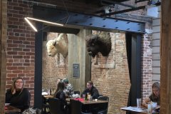 Historic Brick Restaurant Interior with Bison Mounts, Downtown Golden, Colorado — Front Range Dining Scene