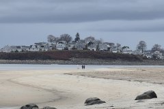 Low Tide Walkers Beneath Coastal Homes at Hampton Harbor