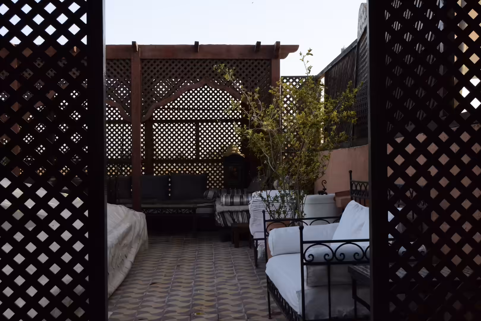 Traditional courtyard seating area with lattice wood panels in Marrakech
