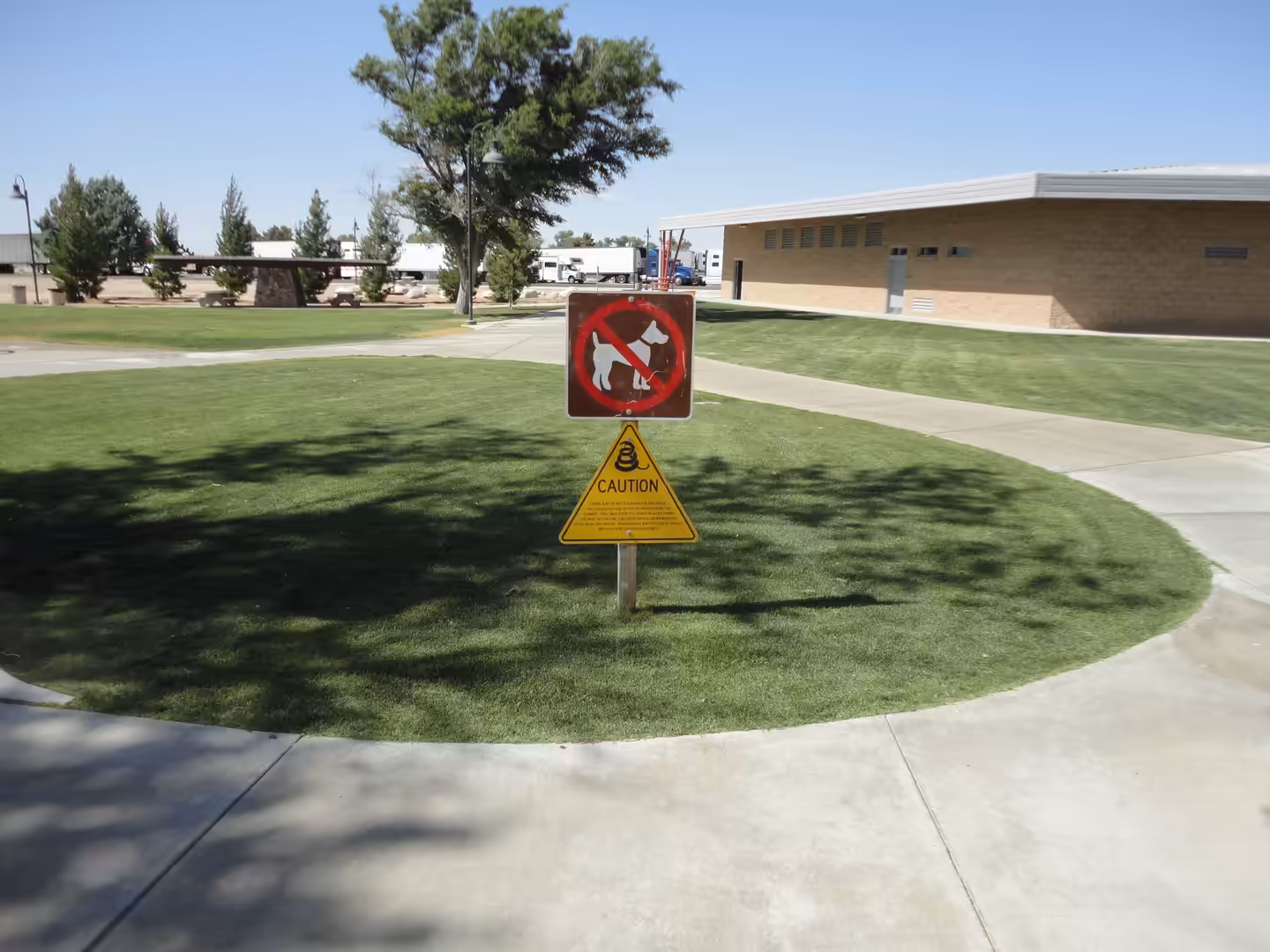 Warning signs on a lawn at a roadside rest area