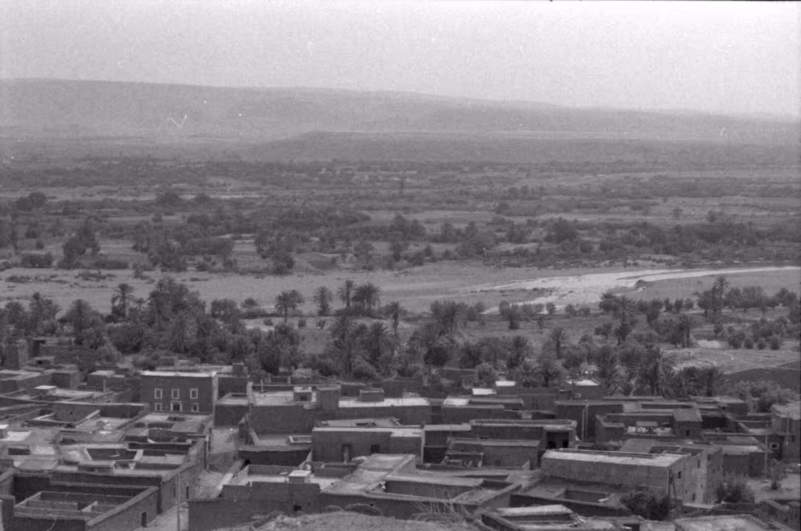 Traditional village and palm oasis beside a river valley in southern Morocco