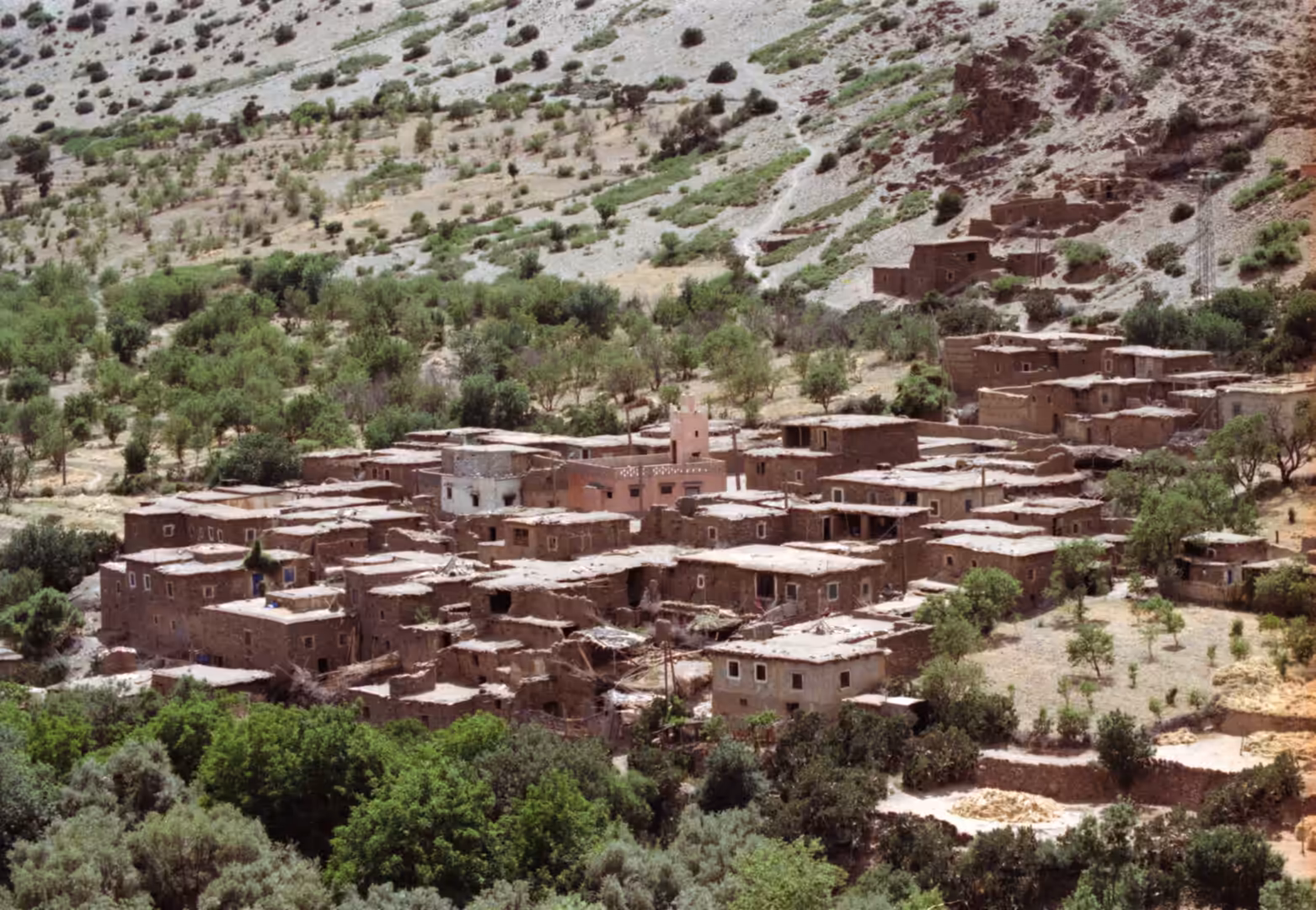 Traditional mountain village with mud-brick houses and small mosque