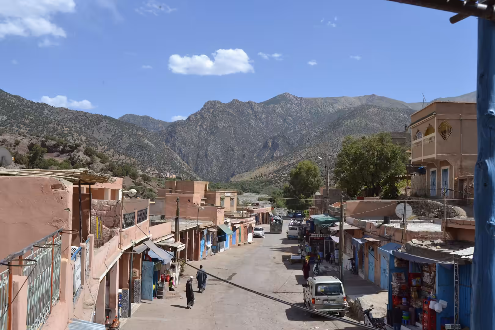 Small town street with Atlas Mountains in the background in Morocco