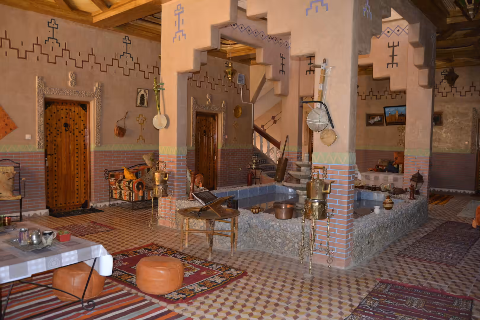 Traditional Moroccan riad interior with fountain and decorative arches