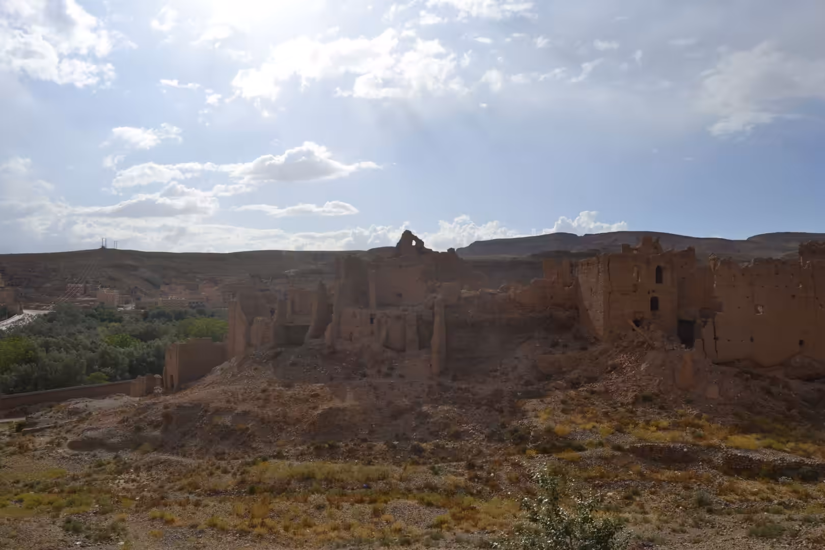 Ruins of an old earthen kasbah on a hill in the Moroccan desert