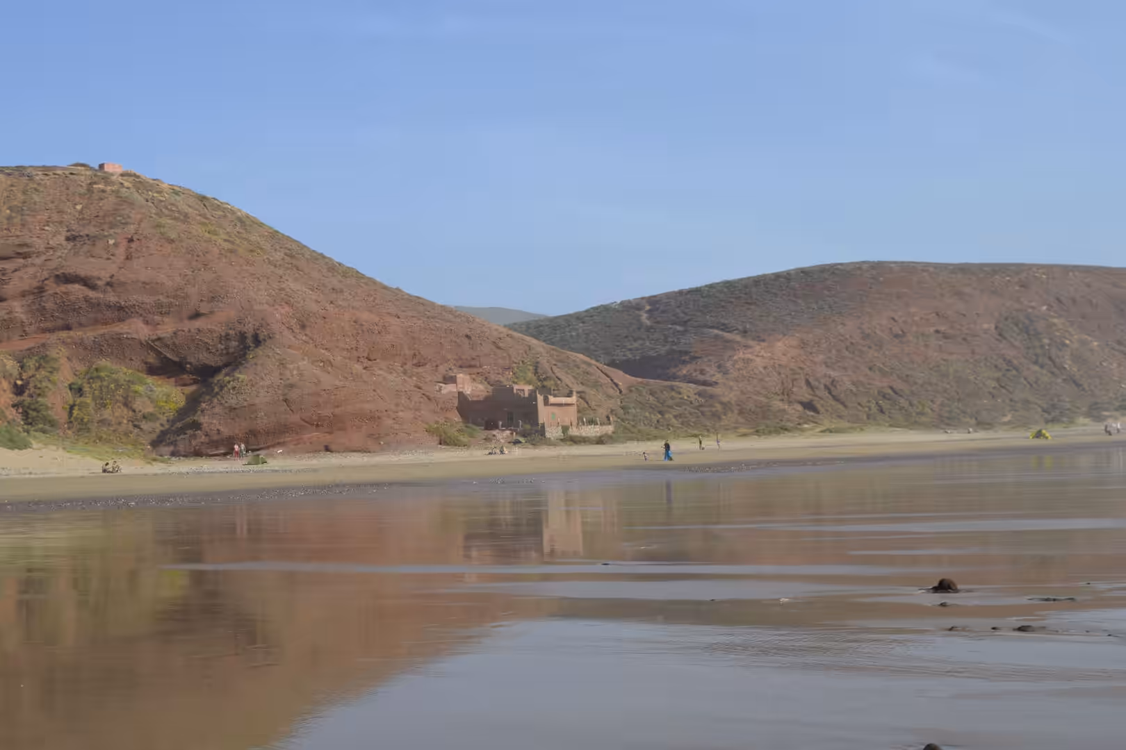 Beach with red hills on the Atlantic coast of Morocco