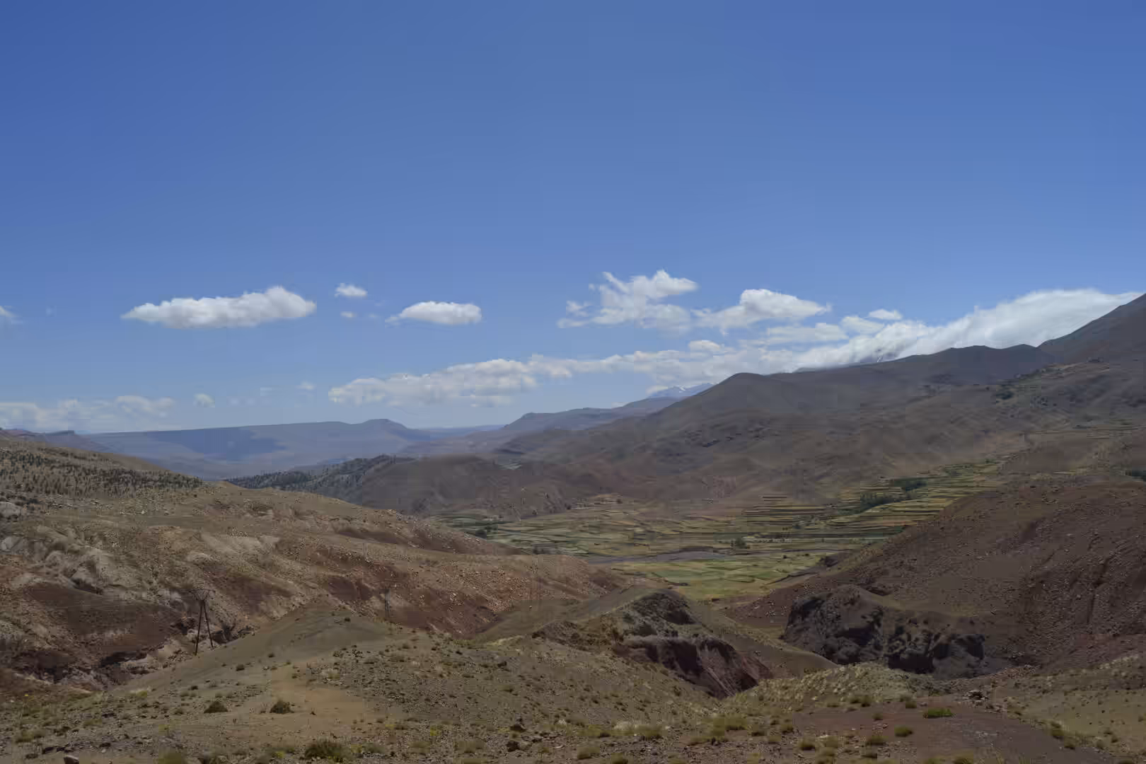 Terraced fields in a mountain valley surrounded by arid hills