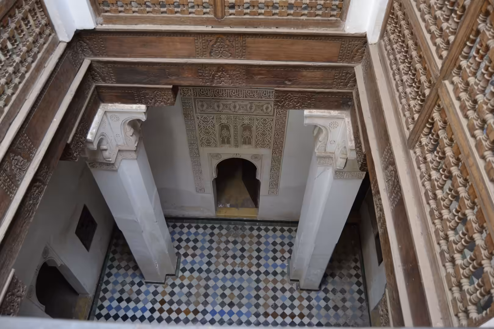Interior balcony view overlooking tiled floor at Ben Youssef Madrasa