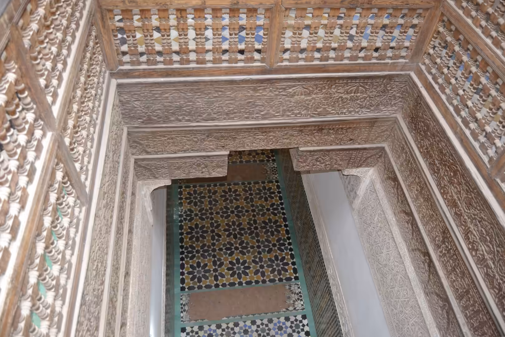 Balcony view of geometric tile floor at Ben Youssef Madrasa