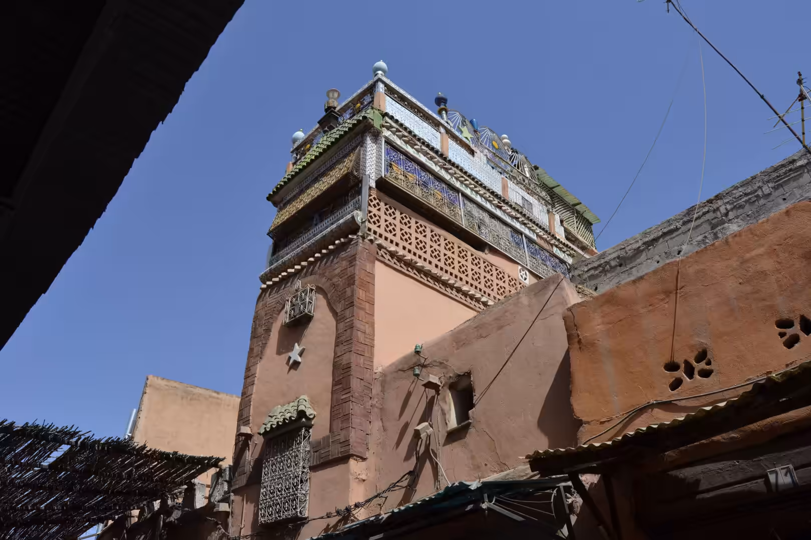 Decorative minaret rising above buildings in the Medina of Marrakech