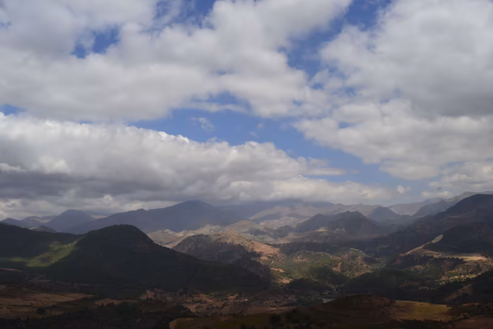 Layered mountain ridges beneath dramatic clouds in the Atlas Mountains