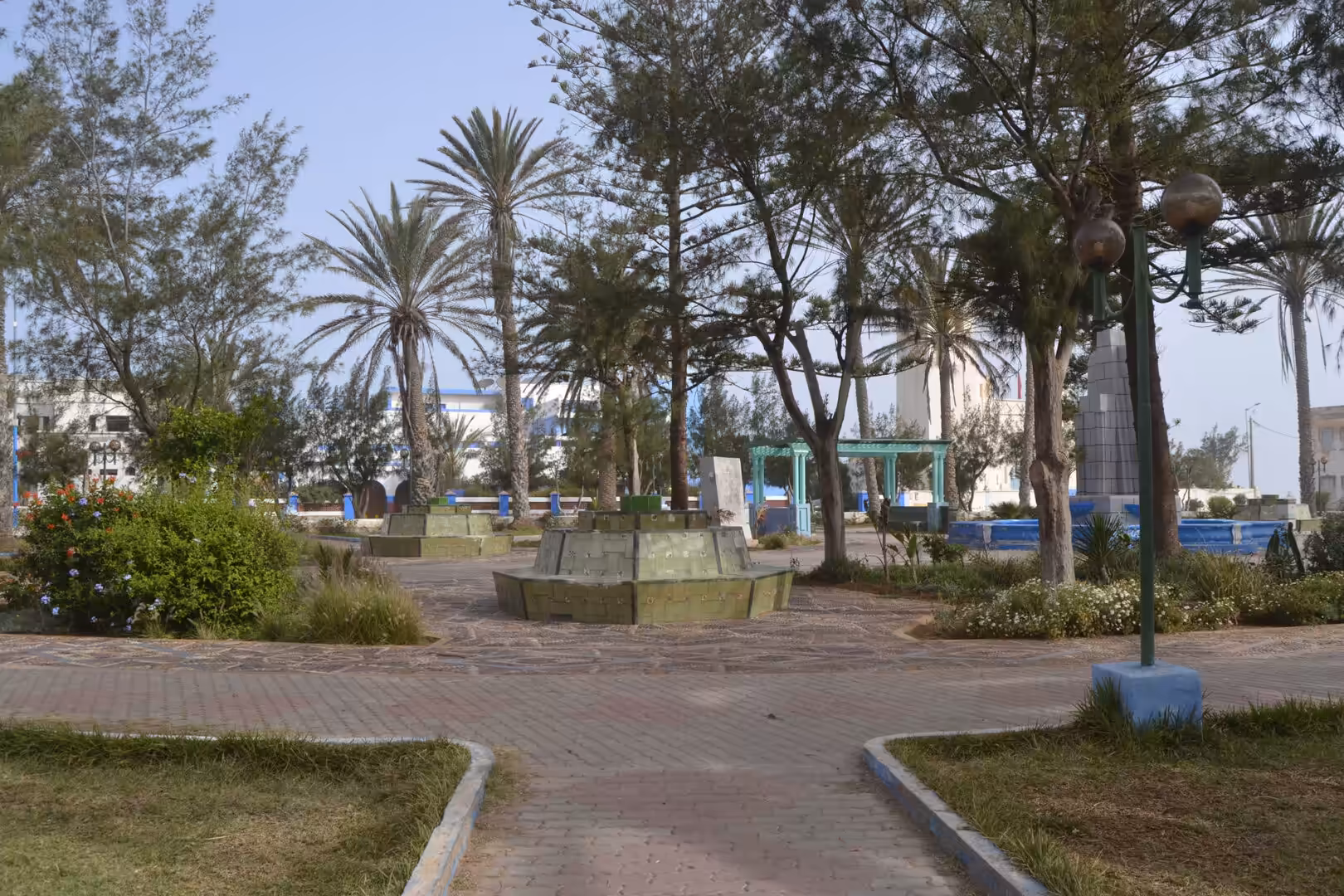 Palm trees and pathways in a public square in Sidi Ifni, Morocco