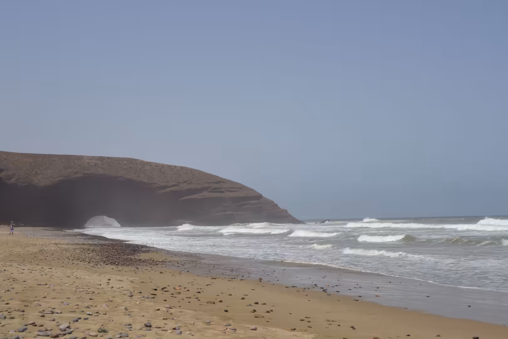 Natural rock arch and waves along the shoreline at Legzira Beach