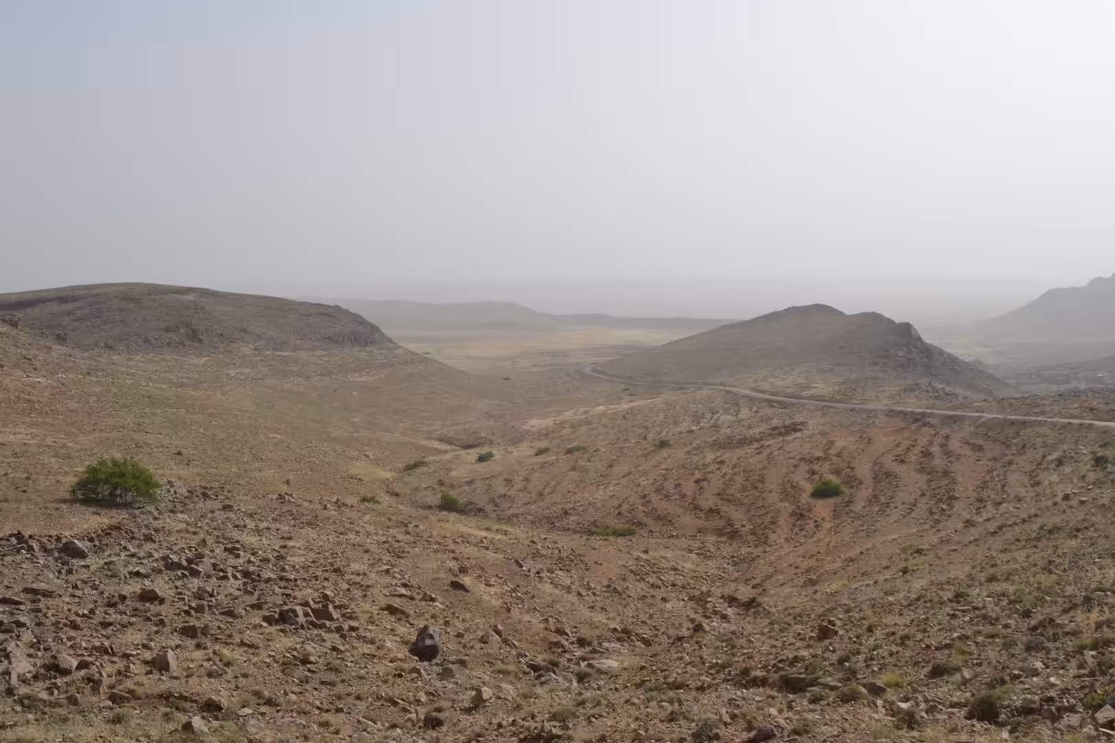 Arid valley with winding road in the Anti-Atlas Mountains, Morocco