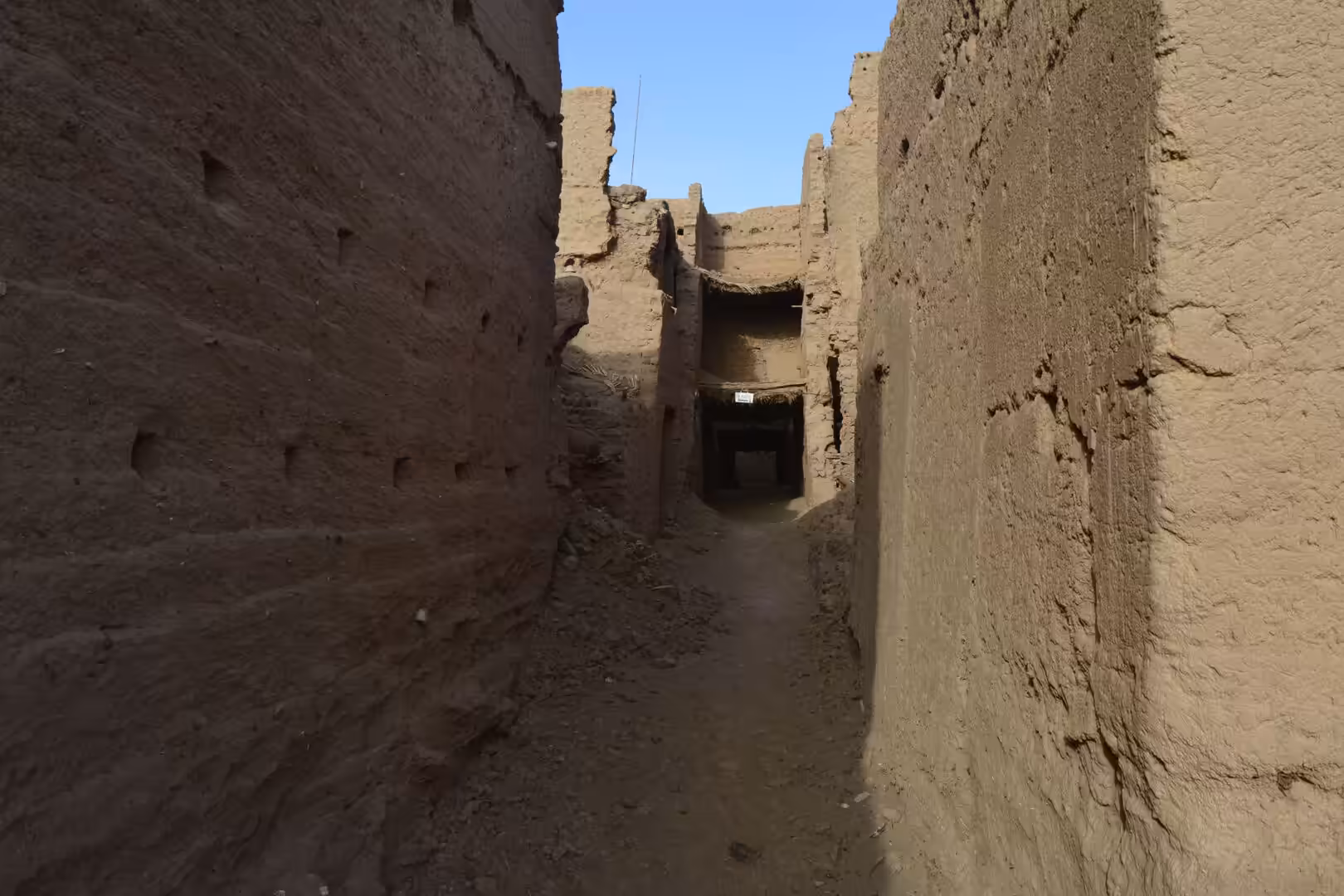 Narrow alley between earthen walls in Moroccan kasbah