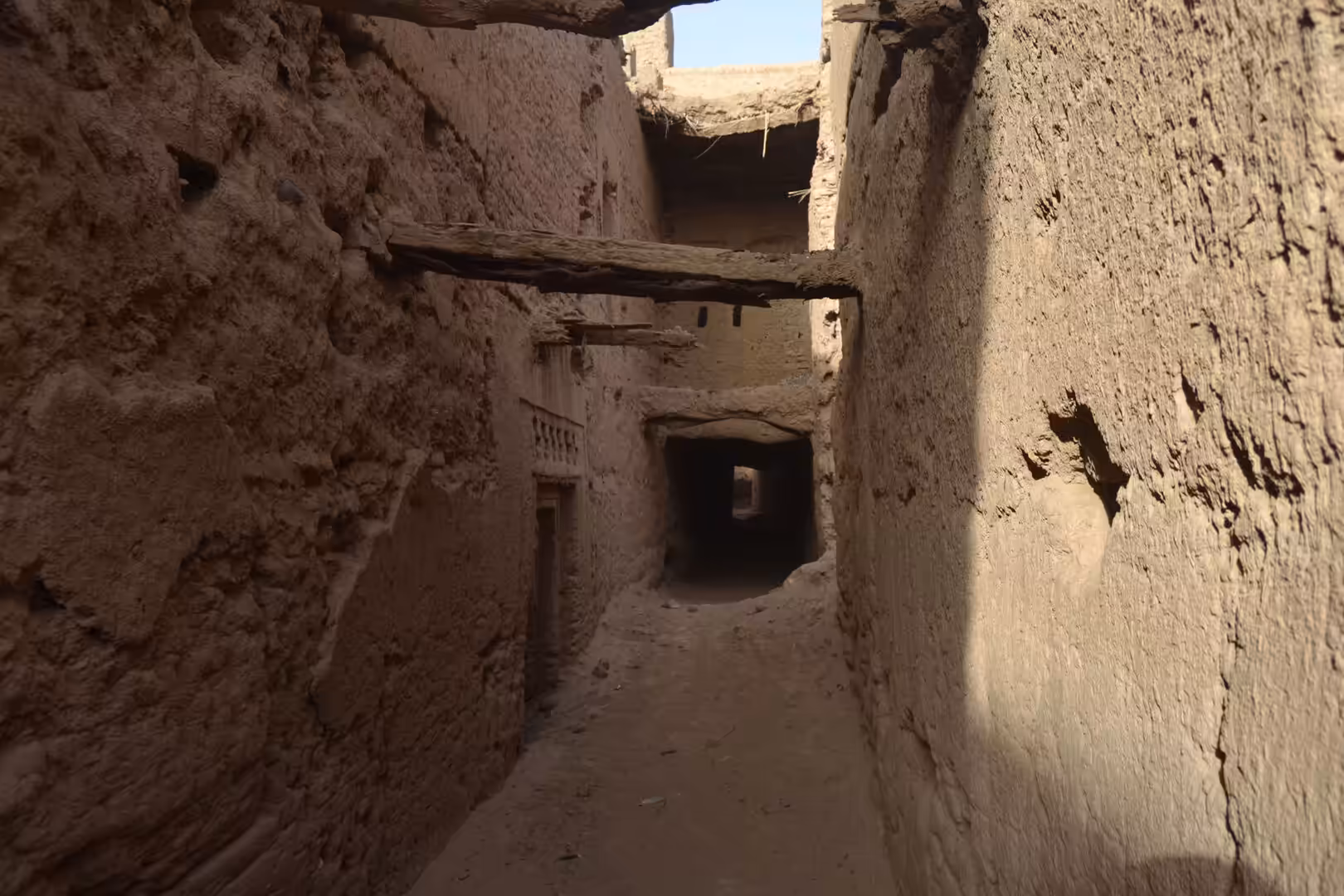 Narrow adobe alley with wooden beams in kasbah