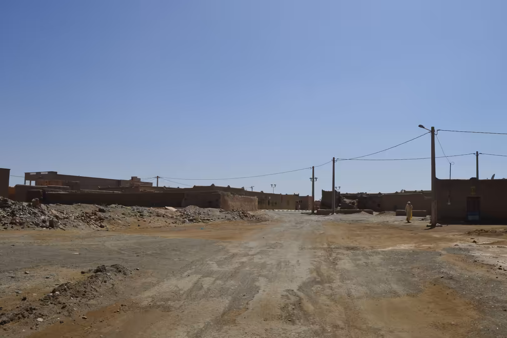 Dusty road through desert village near Merzouga
