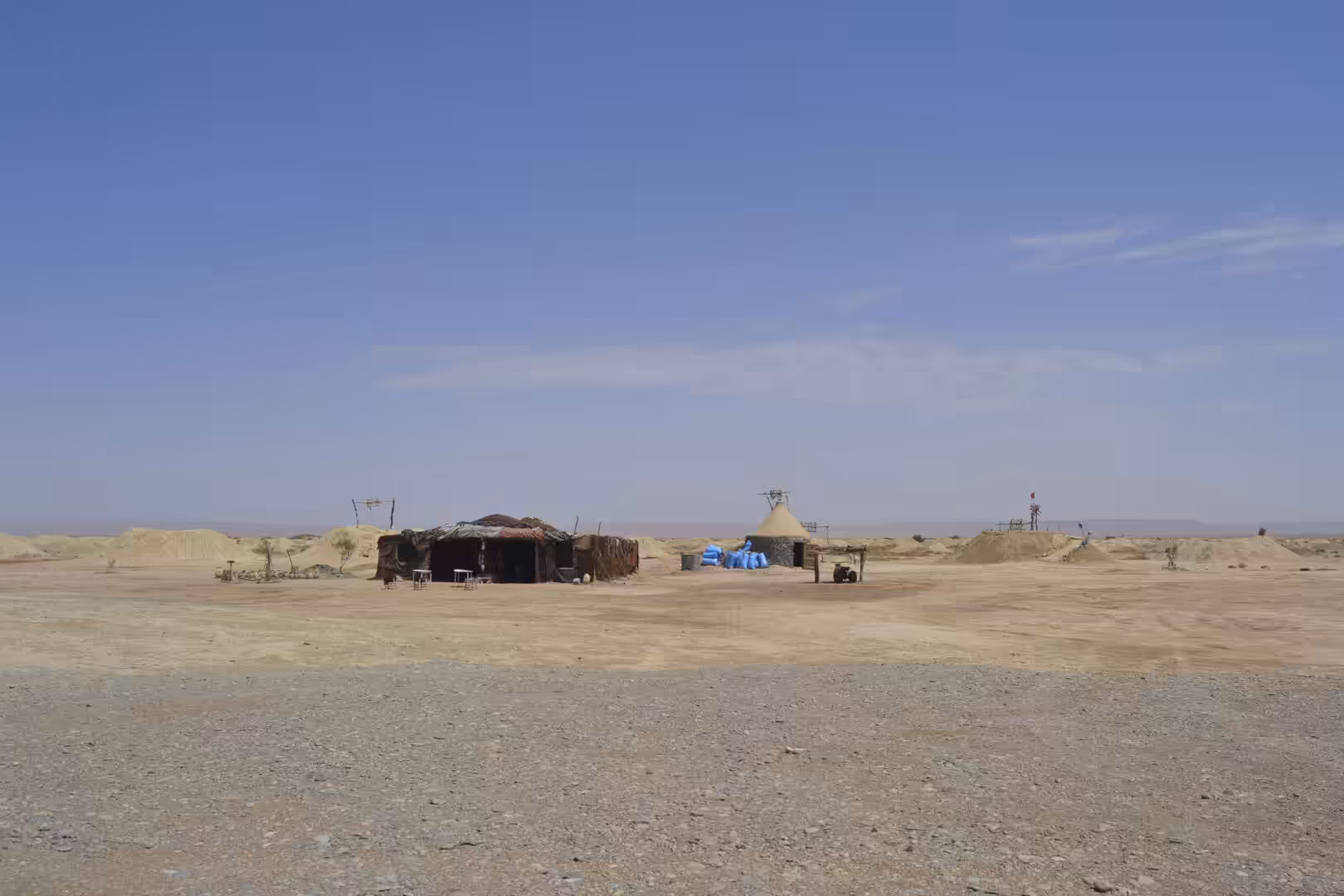Nomadic huts in remote desert landscape