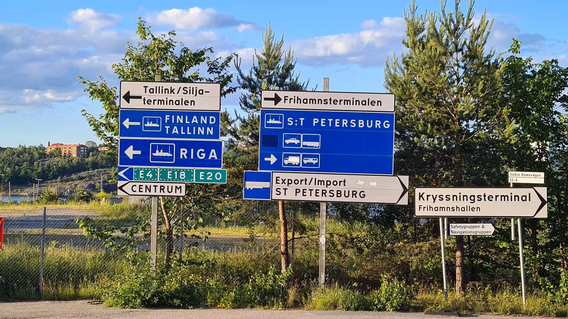 White and blue signs point the way to ferries for Finland, Riga and St Petersburg.