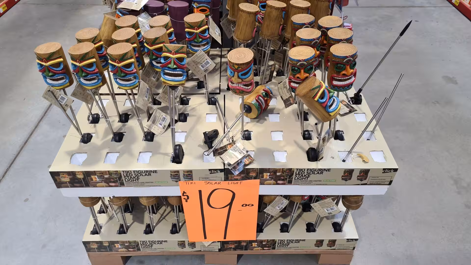 A store shelf of tiki figurine solar lights on special offer.