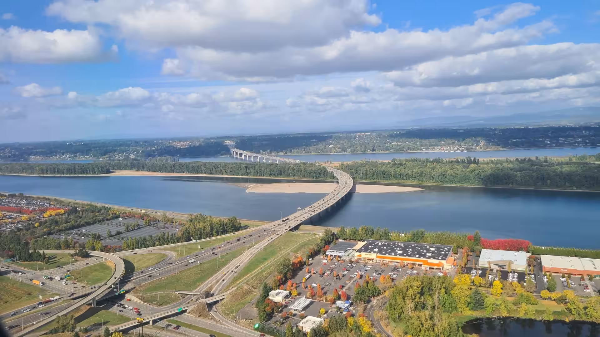 Highway bridges crossing the Columbia River near Portland with urban landscape and autumn colors