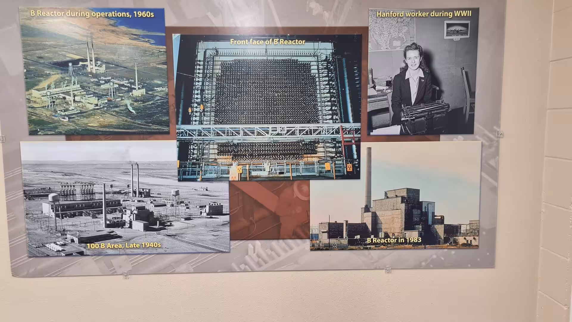 Museum display featuring historical photographs of the Hanford B Reactor during operation from the 1940s to the 1980s
