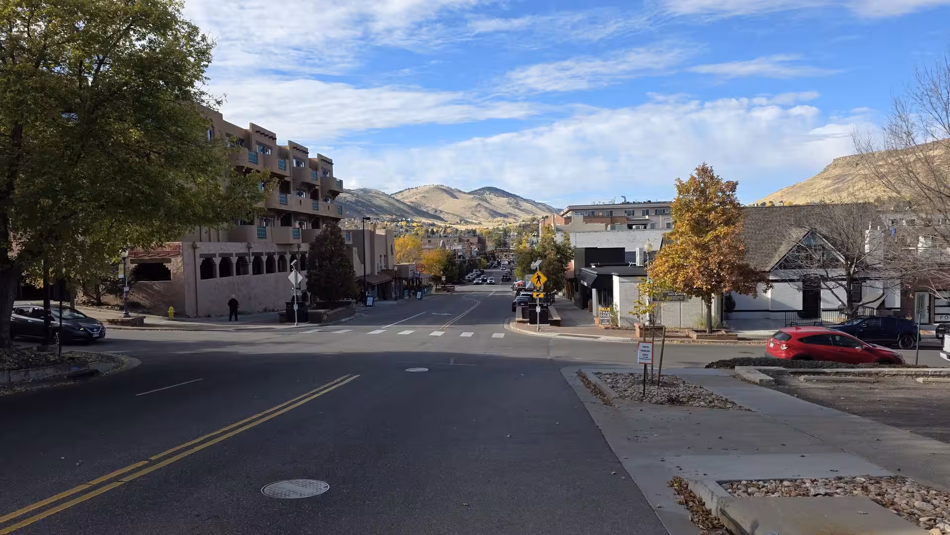 Street view in Golden, Colorado with foothills and autumn trees