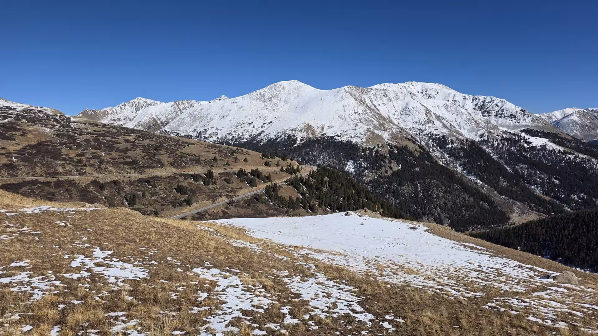 Panoramic view of snow-covered Rocky Mountain peaks and alpine slopes along Independence Pass in Colorado