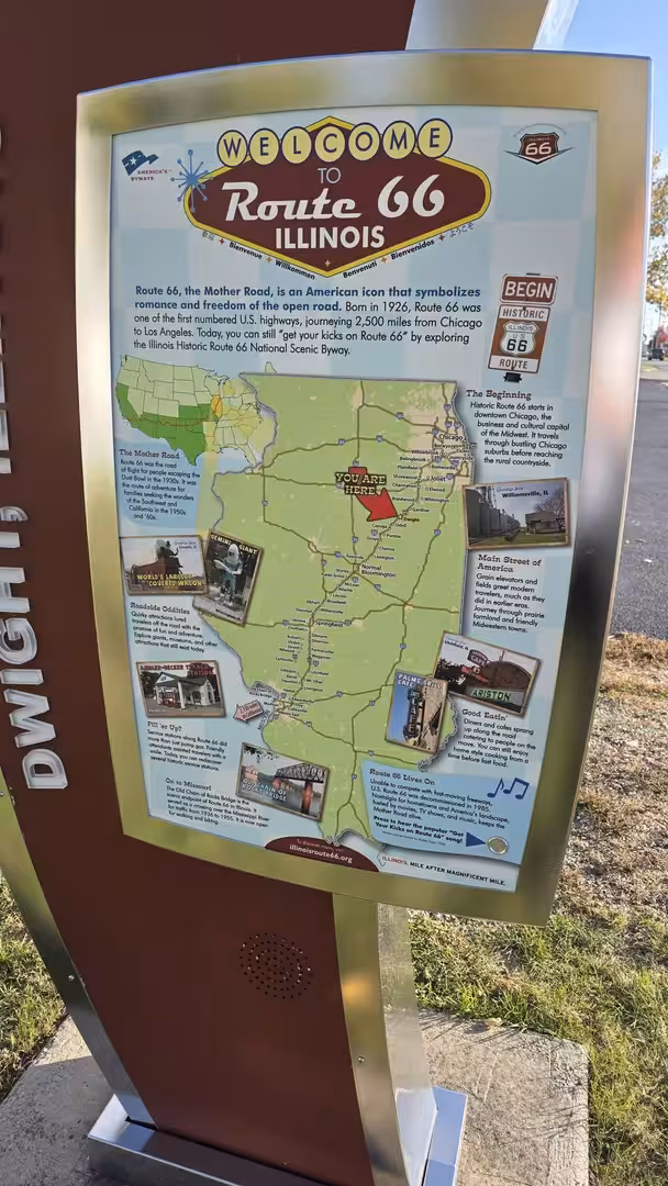 Route 66 Illinois welcome sign with historic map and travel information beside the roadside.
