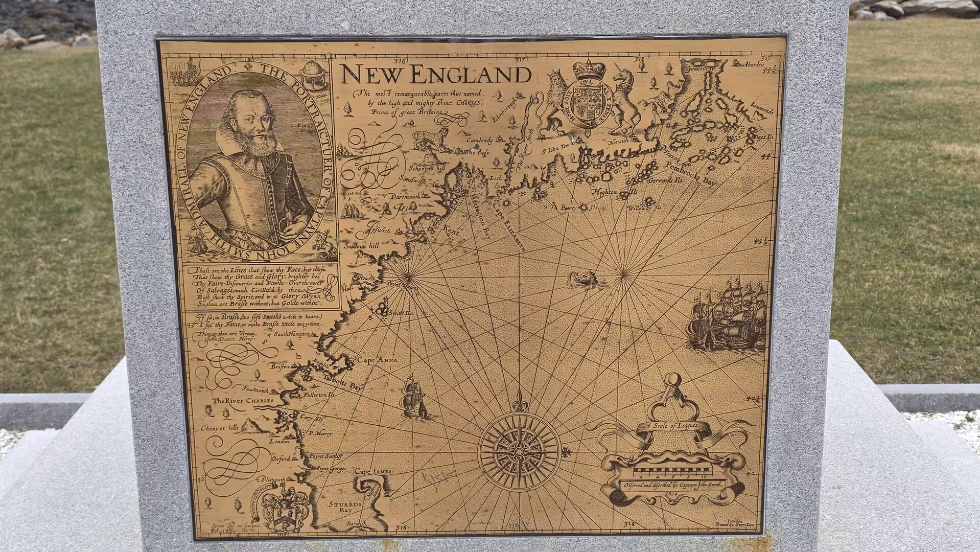 Historic engraved map of New England displayed on a stone monument, featuring decorative cartography, coastal details, and an early colonial portrait.
