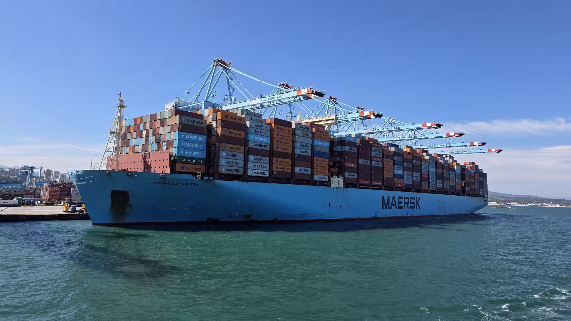 Large Maersk container ship loaded with cargo containers at the Port of Algeciras.