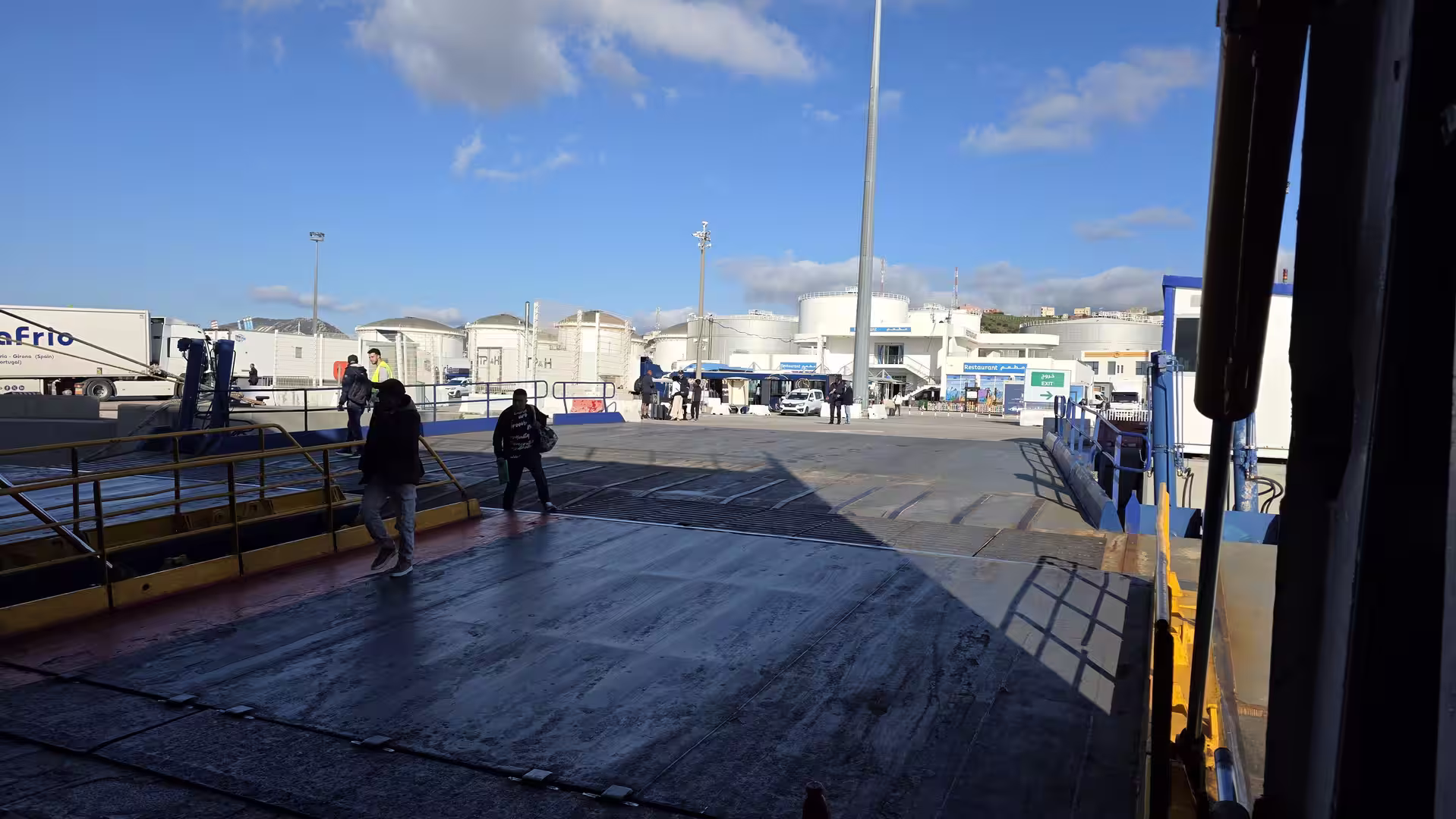 Vehicles and passengers disembarking from a ferry at Tangier Med port in Morocco.